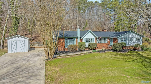 view of front of home with brick siding, a front lawn, crawl space, a storage shed, and an outbuilding