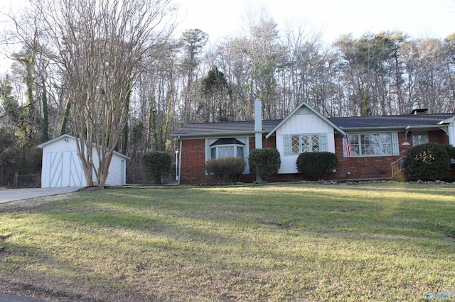 ranch-style home featuring brick siding, a front yard, and an outdoor structure