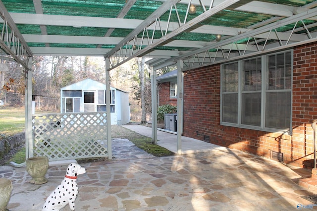 view of patio with a storage shed