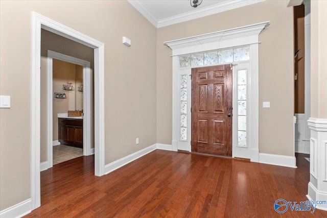 entrance foyer with dark hardwood / wood-style flooring and crown molding