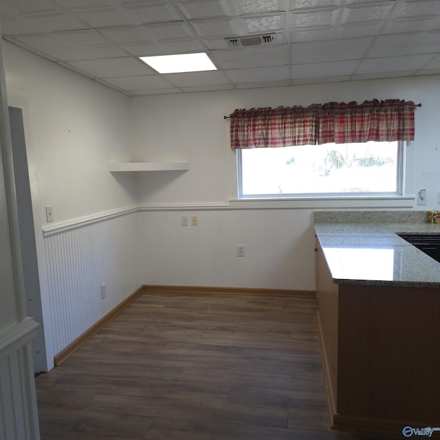 interior space featuring visible vents, wainscoting, a paneled ceiling, and wood finished floors