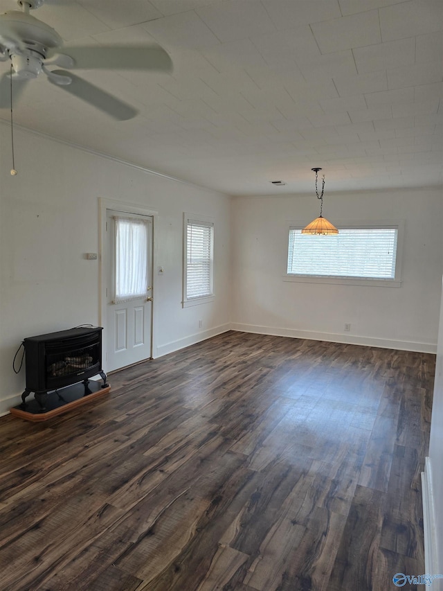 unfurnished living room featuring baseboards, dark wood-style flooring, and ceiling fan