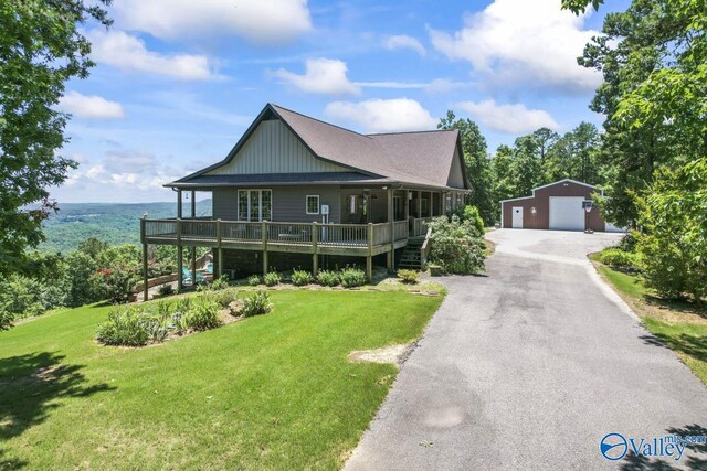 8879 County Road 27, Springville, AL 35146 - view of front of house featuring an outbuilding, a detached garage, a front yard, and a porch