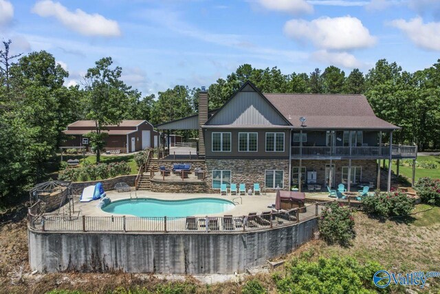 8879 County Road 27, Springville, AL 35146 - view of swimming pool featuring a patio, a wooden deck, and view of wooded area