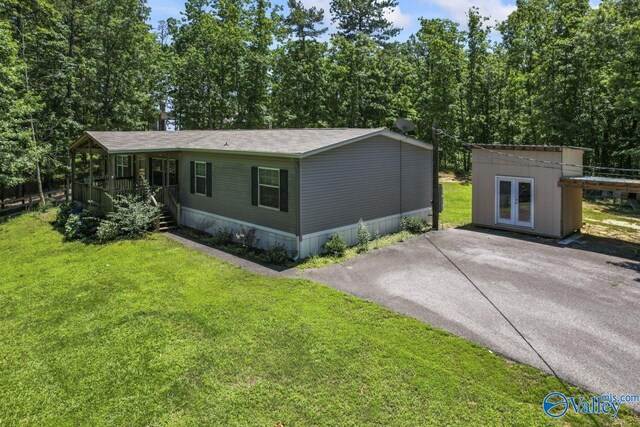 8879 County Road 27, Springville, AL 35146 - view of front of home with a front lawn, covered porch, and french doors