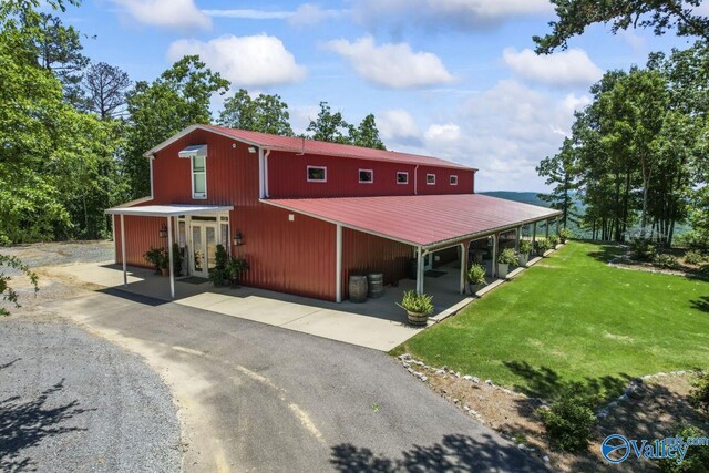8879 County Road 27, Springville, AL 35146 - view of front of home featuring french doors, metal roof, a front yard, and driveway