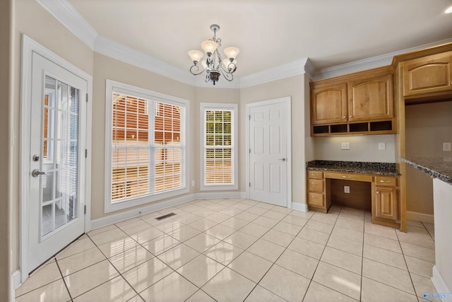 unfurnished dining area featuring built in desk, baseboards, a notable chandelier, ornamental molding, and light tile patterned flooring