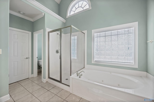 full bathroom featuring a jetted tub, tile patterned flooring, toilet, and a shower stall