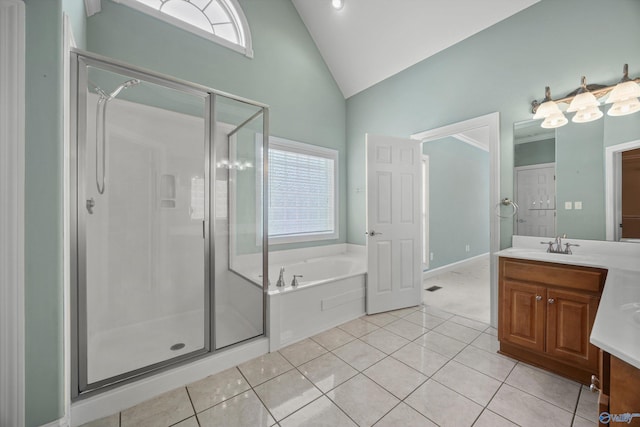 full bathroom featuring vanity, a garden tub, tile patterned floors, a stall shower, and vaulted ceiling