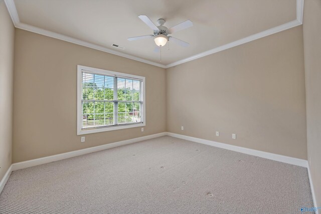 spare room featuring baseboards, ornamental molding, carpet, and visible vents