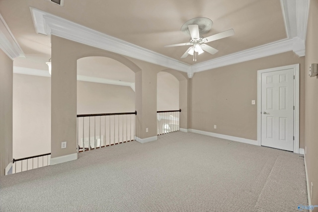 carpeted empty room featuring baseboards, a ceiling fan, and ornamental molding