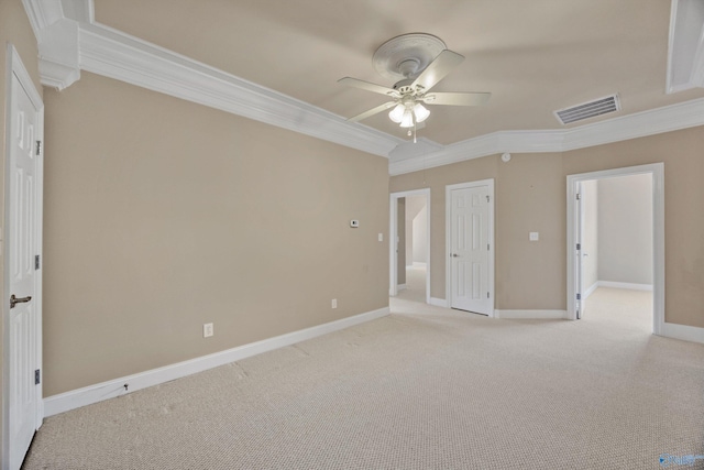 unfurnished bedroom with visible vents, ornamental molding, baseboards, and light carpet
