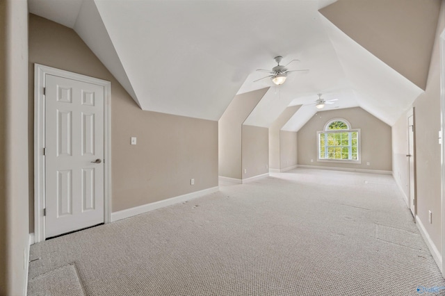 bonus room featuring baseboards, a ceiling fan, lofted ceiling, and light carpet