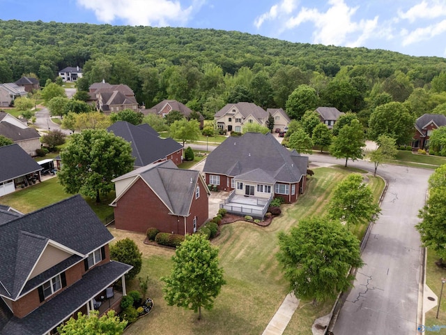 aerial view featuring a view of trees and a residential view