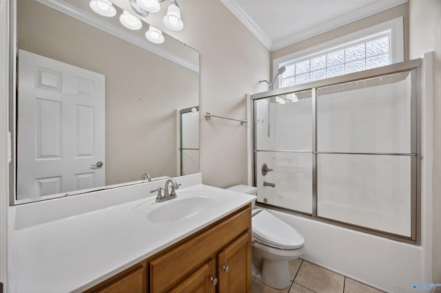 bathroom with crown molding, vanity, shower / bath combination with glass door, toilet, and tile patterned floors
