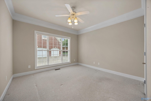spare room featuring carpet floors, ornamental molding, and baseboards
