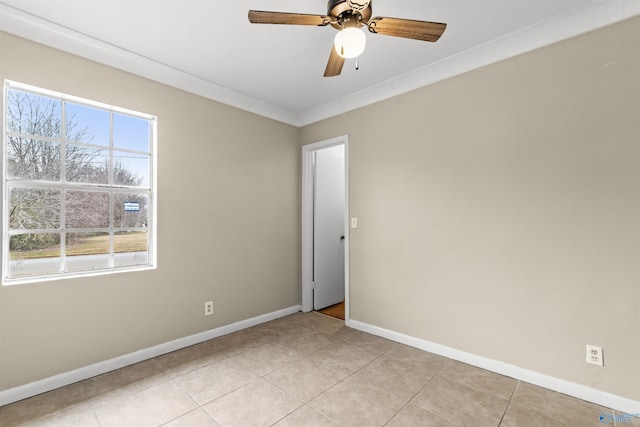unfurnished room featuring baseboards, ornamental molding, a ceiling fan, and light tile patterned floors