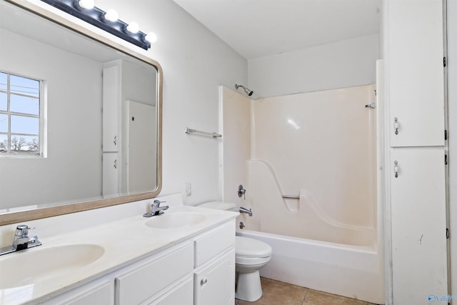 full bathroom featuring toilet, a sink, double vanity, and tile patterned flooring