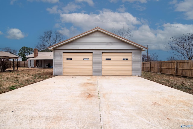 detached garage featuring fence