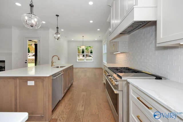 kitchen featuring stainless steel appliances, white cabinetry, a large island, and pendant lighting