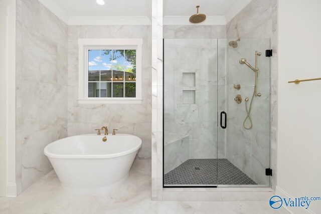 bathroom featuring separate shower and tub, tile patterned flooring, and tile walls