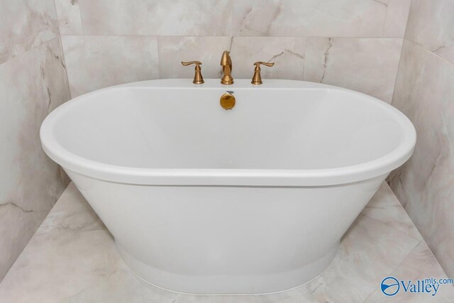 bathroom with tile patterned flooring and tile walls