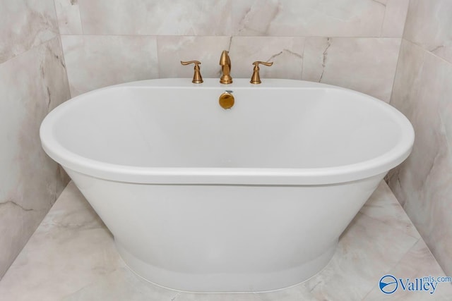 bathroom featuring a bathtub and tile walls