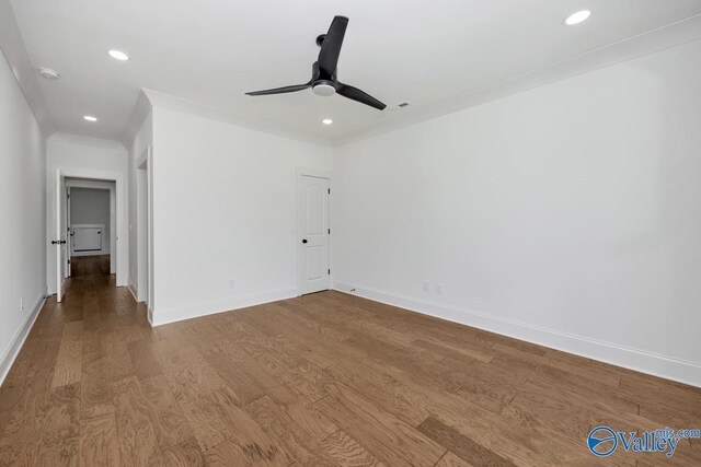 empty room with ornamental molding, hardwood / wood-style floors, and ceiling fan