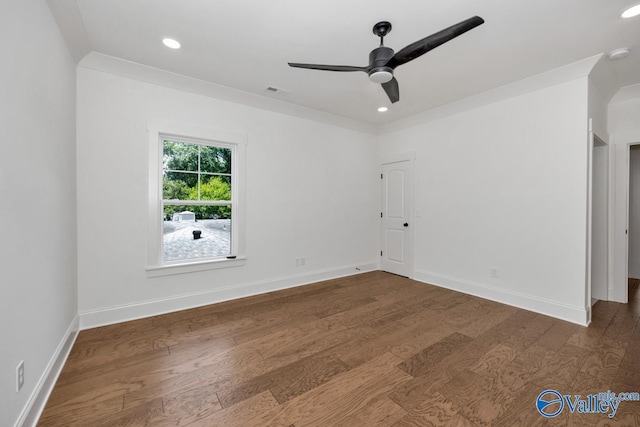 empty room featuring crown molding, dark hardwood / wood-style floors, and ceiling fan