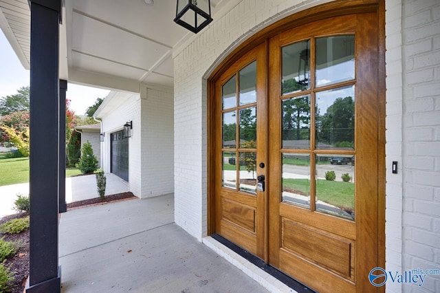 entrance to property with a garage and covered porch