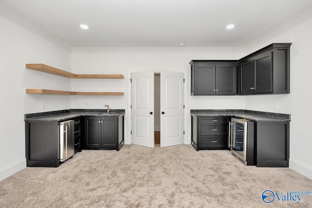 kitchen featuring light colored carpet, wine cooler, and refrigerator