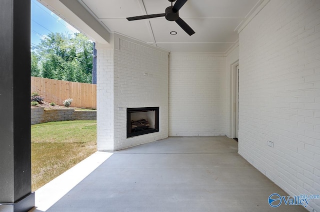 view of patio / terrace featuring an outdoor brick fireplace and ceiling fan