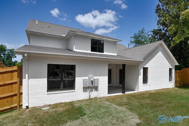 back of property featuring a yard and a patio