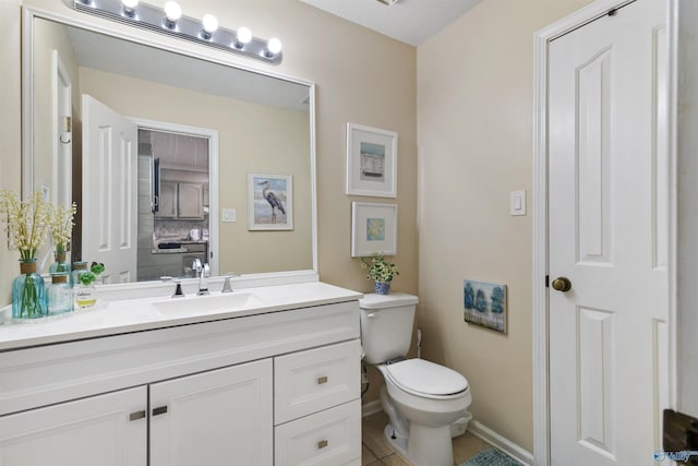 bathroom with baseboards, toilet, and vanity