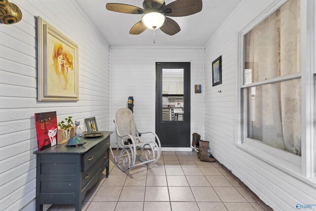 living area featuring light tile patterned flooring and a ceiling fan
