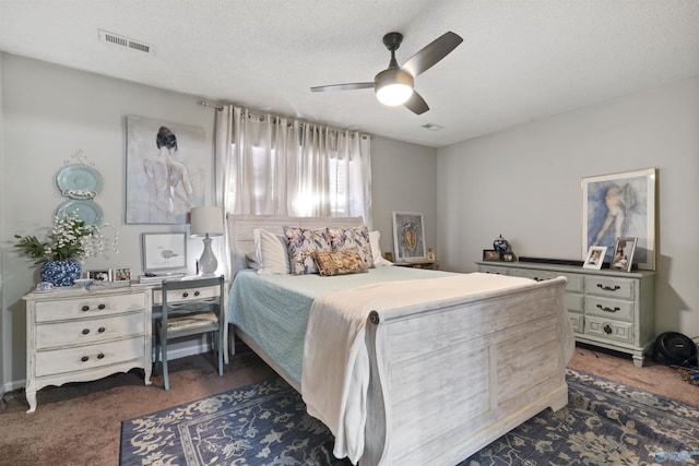 carpeted bedroom with a ceiling fan, a textured ceiling, and visible vents