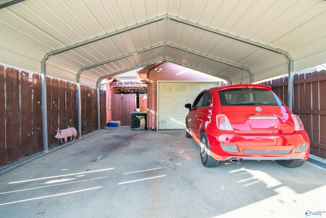 garage with fence and a carport