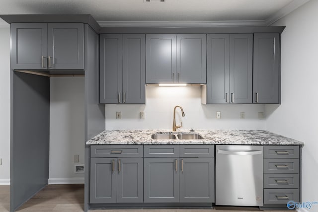 kitchen featuring gray cabinets, light stone countertops, dishwasher, and sink