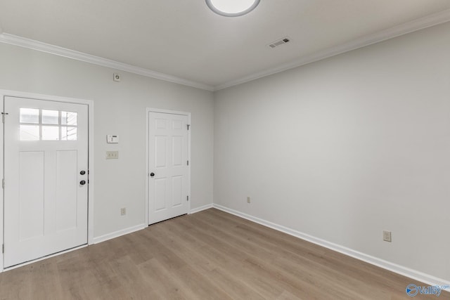 foyer featuring light hardwood / wood-style floors and ornamental molding