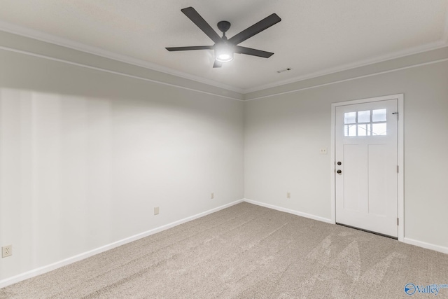 spare room with carpet floors, ceiling fan, and crown molding