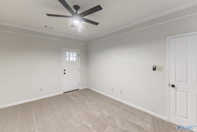 carpeted empty room featuring ceiling fan and crown molding