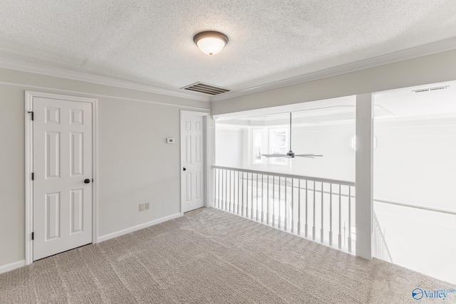 unfurnished room with ceiling fan, carpet floors, a textured ceiling, and ornamental molding