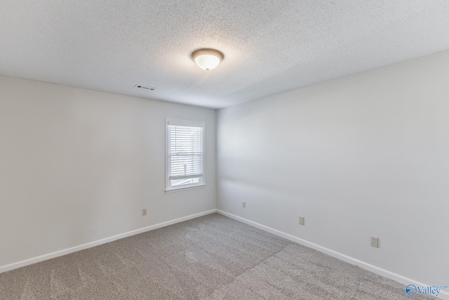 unfurnished room featuring a textured ceiling and carpet floors