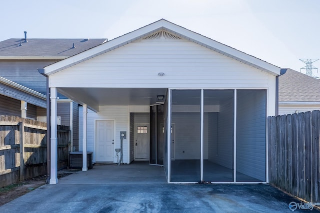 exterior space featuring a sunroom and a carport