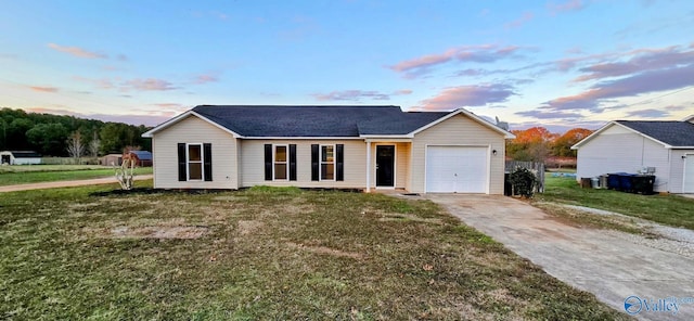 view of front of property with a lawn and a garage