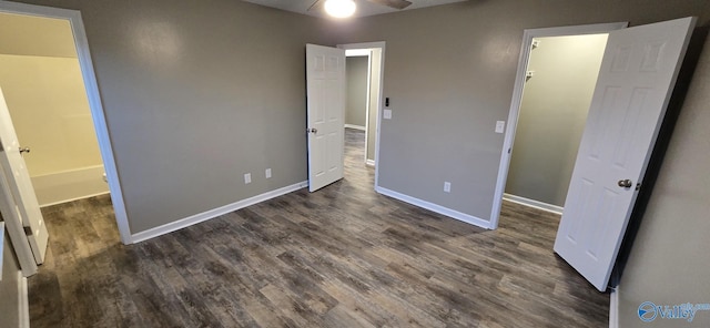 unfurnished bedroom featuring ceiling fan and dark hardwood / wood-style floors