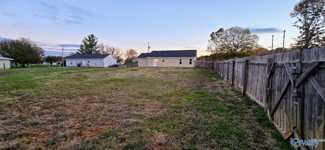 view of yard at dusk