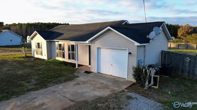 ranch-style house with a garage and a front lawn