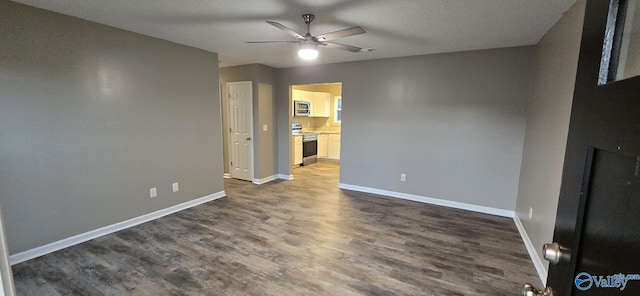 interior space featuring ceiling fan, dark hardwood / wood-style flooring, and a textured ceiling