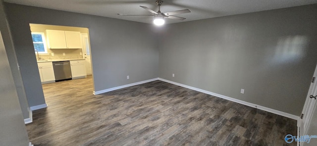 empty room with ceiling fan, wood-type flooring, and a textured ceiling